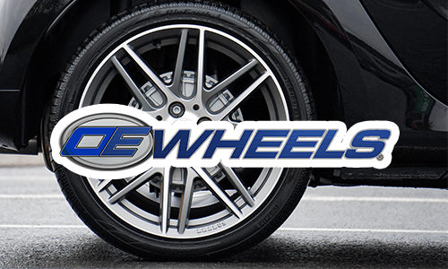 OE Wheels logo in front of car